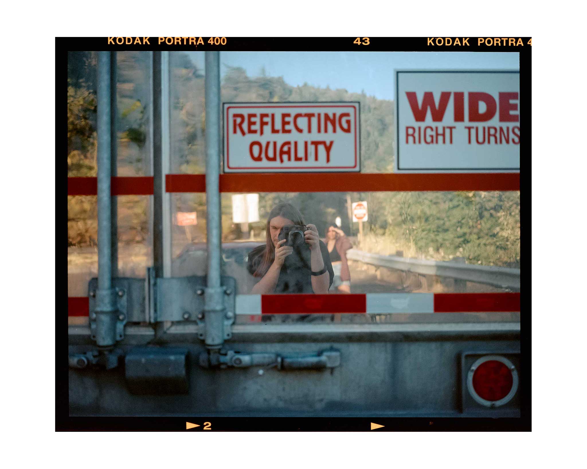 Reflection of myself and Annesah in the back of a mirrored truck, taken on my new Mamiya 7